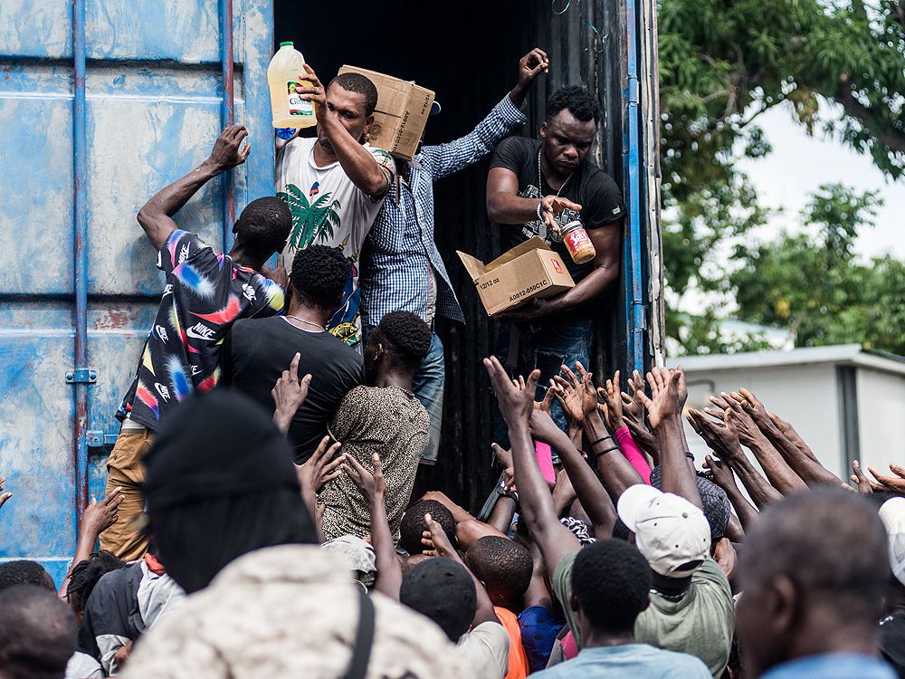 Almost A Week After Quake, Desperate Haitians Loot Aid Trucks | Toronto Sun