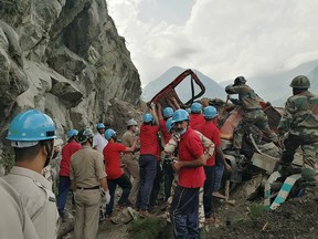 Indo-Tibetan Border Police (ITBP) personnel remove a damaged truck during a rescue operation at the site of a landslide in Kinnaur district in the northern state of Himachal Pradesh, India, August 11, 2021.