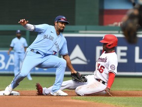 Washington Nationals' Victor Robles slides safely into second base as Blue Jays' Marcus Semien looks on during the first inning at Nationals Park on Wednesday, Aug. 18, 2021.