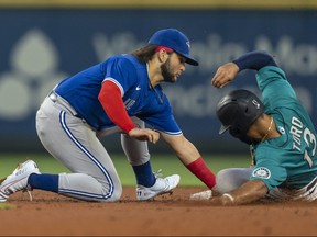 Shortstop Bo Bichette of the Toronto Blue Jays tags out Abraham Toro-Hernandez of the Seattle Mariners during the fourth inning of a game at T-Mobile Park on Aug. 13, 2021 in Seattle, Wash.