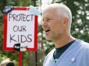 Dr. Joe Vipond and hundreds of Edmontonians rally against the recent provincial removal of all COVID-19 restrictions, outside the Alberta Legislature in Edmonton Tuesday Aug. 3, 2021.