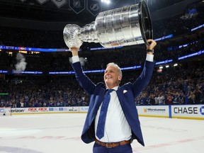 Head coach Jon Cooper of the Tampa Bay Lightning hoists the Stanley Cup after the 1-0 victory against the Montreal Canadiens in Game 5  to win the 2021 NHL Stanley Cup Final at Amalie Arena on July 7, 2021 in Tampa, Fla.
