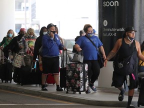 Passengers queue at LAX airport before Memorial Day weekend, in Los Angeles, May 27, 2021.