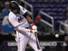 Miami Marlins left fielder Lewis Brinson (25) doubles against the New York Mets at loanDepot park.