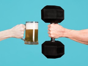 A muscular male hand holds out a heavy dumbbell towards a glass with beer in the other man s hand. Contrasting alcoholism with sports