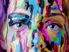 Close Up Of Woman's Face Covered In Dripping Paint