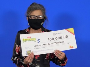 Laurie Ann Sprague of Hamilton with her lottery winnings