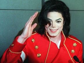 In this file photo taken on March 19, 1996 Michael Jackson waves to photographers during a press conference in Paris.