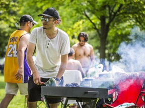 Karam Laham prepares the charcoal for barbequing in Woodbine Beach Park on Sunday June 13, 2021.