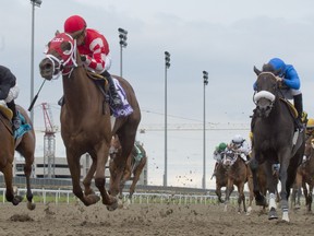 Munnyfor Ro, ridden by Justin Stein, wins the $500,000 Woodbine Oaks at Woodbine Racetrack in Toronto on Aug. 1, 2021.