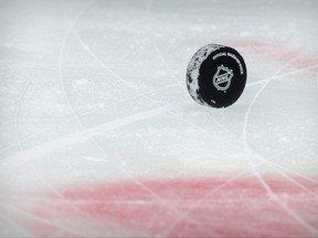 A view of a puck and the NHL logo and the face-off circle before the game between the Dallas Stars and the Detroit Red Wings at the American Airlines Center in Dallas.