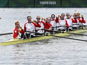 Gold medallists coxswain Kristen Kit of Canada, Avalon Wasteneys of Canada, Sydney Payne of Canada, Madison Mailey of Canada, Susanne Grainger of Canada, Andrea Proske of Canada, Christine Roper of Canada, Kasia Gruchalla-Wesierski of Canada and Lisa Roman of Canada celebrate in their boat with their medals at the Sea Forest Waterway in Tokyo on July 30, 2021.