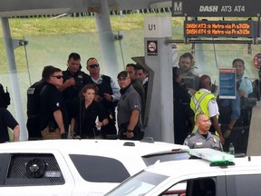 Law enforcement officers gather near the entrance of the Pentagon after a report of an active shooter and lockdown in Washington, D.C., Tuesday, Aug. 3, 2021.