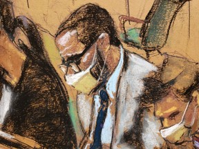 R. Kelly sits with his defence lawyers during his sex abuse trial at Brooklyn's Federal District Court in a courtroom sketch in New York City, Tuesday, Aug. 31, 2021.