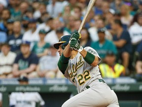 Oakland Athletics center fielder Ramon Laureano (22) hits a single against the Seattle Mariners at T-Mobile Park.
