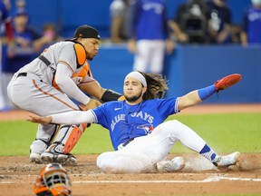Blue Jays' Bo Bichette is safe at home plate as he slides past Pedro Severino of the Baltimore Orioles in in the sixth inning at the Rogers Centre on Aug. 30, 2021 in Toronto.