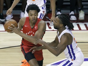 Scottie Barnes (left) of the Toronto Raptors drives against Wayne Selden of the New York Knicks during NBA Summer League action in Las Vegas on Sunday. The Raptors defeated the Knicks 89-79.