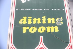A bullet went through the Grossman’s Tavern sign high above the bar’s front door across the street from where two men were shot to death — and two wounded — on Sunday morning at Spadina Ave. just north of Nassau St. JACK BOLAND/TORONTO SUN