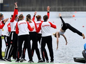 Canada coxswain Kristen Kit is tossed into the water after her women’s eights won the Olympic gold medal.
