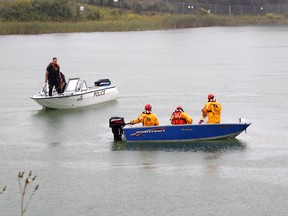An Ontario Provincial Police marine unit, along with a team from the Timmins Fire Department, are seen conducting a search for a vehicle that went into Little Pearl Lake.