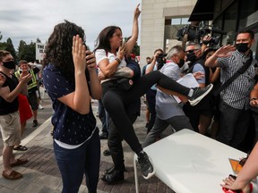 A protester reacts as Liberal Leader Justin Trudeau arrives at his election campaign tour in Bolton, Ont., Friday, Aug. 27, 2021.