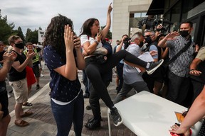 A protester reacts as Liberal Leader Justin Trudeau arrives at his election campaign tour in Bolton, Ont., Friday, Aug. 27, 2021.