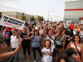 Protesters react after an event was cancelled during Liberal Leader Justin Trudeau's campaign in Bolton, Ont., Friday, Aug. 27, 2021.