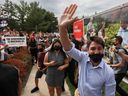 Liberal Prime Minister Justin Trudeau waves during his election campaign tour in Nobleton, Ont., Aug. 27, 2021.