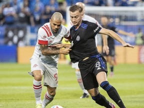 CF Montreal's Djordje Mihailovic challenges Toronto FC's Auro Alvaro da Cruz Junior, left,  during first half MLS soccer action in Montreal last night. THE CANADIAN PRESS/Graham Hughes