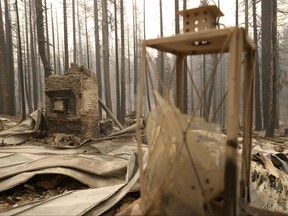 The chimney stands in the burnt remains of a home that was destroyed by the Caldor Fire on Aug. 31, 2021 in Twin Bridges, Calif.