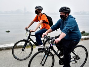 Cyclists wear masks in Stanley Park in Vancouver, Sept. 14, 2020.