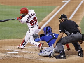 Washington Nationals' Yadiel Hernandez hits a solo home run against the Toronto Blue Jays in the second inning at Nationals Park on Tuesday, Aug. 17, 2021.