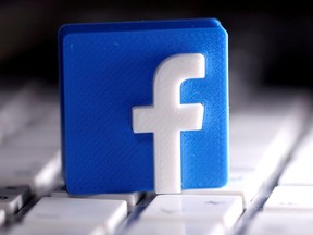 A 3D-printed Facebook logo is seen placed on a keyboard in this illustration taken March 25, 2020.