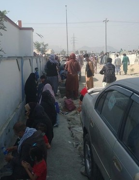 Afghans wait near Kabul airport to be rescued on Saturday, Aug. 21, 2021.