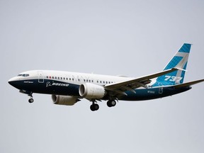 In this file photo taken on September 30, 2020 a Boeing 737 MAX airliner piloted by Federal Aviation Administration (FAA) Administrator Steve Dickson lands following an evaluation flight at Boeing Field the in Seattle, Washington.