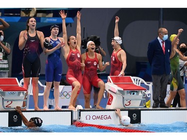 Canada's Penny Oleksiak (3L), Margaret MacNeil (2R), Kayla Sanchez (R) and Rebecca Smith react as they take second place in the women's 4x100m freestyle relay swimming event during the Tokyo 2020 Olympic Games at the Tokyo Aquatics Centre in Tokyo on July 25, 2021. (Photo by Attila KISBENEDEK / AFP)