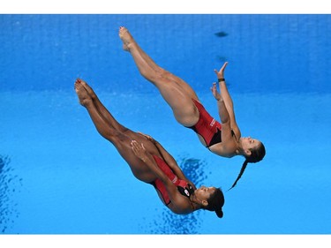Canada's Jennifer Abel and Canada's Melissa Citrini Beaulieu compete to take the silver medal in the women's synchronised 3m springboard diving final event during the Tokyo 2020 Olympic Games at the Tokyo Aquatics Centre in Tokyo on July 25, 2021. (Photo by Oli SCARFF / AFP)