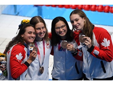 Bronze medallists (from L) Canada's Kylie Masse, Canada's Sydney Pickrem, Canada's Margaret MacNeil and Canada's Penny Oleksiak pose with their medals after the final of the women's 4x100m medley relay swimming event during the Tokyo 2020 Olympic Games at the Tokyo Aquatics Centre in Tokyo on August 1, 2021. (Photo by Jonathan NACKSTRAND / AFP)