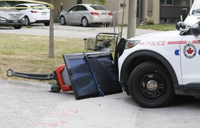 A flat-screen television is tied to a wagon and lies in front of a Durham Regional Police vehicle after a man was injured in a shooting on Tulloch Dr. in Ajax on Friday, Aug. 27, 2021.
