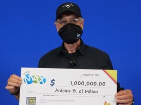 Antoine Beaini holds his Maxmillions winnings.