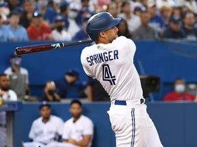 Toronto Blue Jays designated hitter George Springer (4) hits a two-RBI double against Cleveland Indians in the third inning at Rogers Centre.