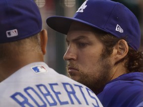 Washington, District of Columbia, USA; Los Angeles Dodgers starting pitcher Trevor Bauer (R) talks with Dodgers manager Dave Roberts (L) in the dugout against the Washington Nationals in the third inning at Nationals Park. Mandatory Credit: Geoff Burke-USA TODAY Sports ORG XMIT: IMAGN-432857