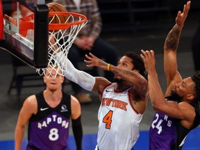 Derrick Rose #4 of the New York Knicks attempts a shot as Khem Birch #24 of the Toronto Raptors defends at Madison Square Garden on April 11, 2021 in New York City.