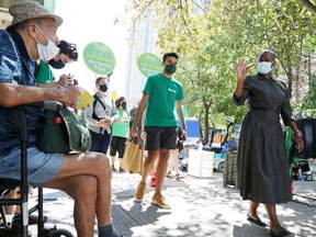 Green Party leader Annamie Paul greets a man as she canvasses a neighbourhood after launching the party's federal election campaign in Toronto, Ontario, Canada August 15, 2021.