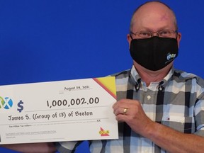 James Stewart of Beeton accepts the winnings on behalf of his co-workers.