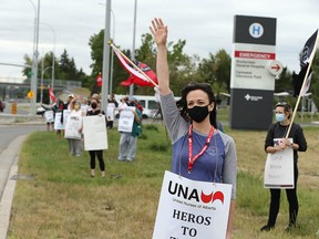 Registered nurse Helen Knight joins colleagues and supporters in front of Rockyview Hospital in Calgary during a "day of action" on Wednesday, Aug. 11, 2021.
