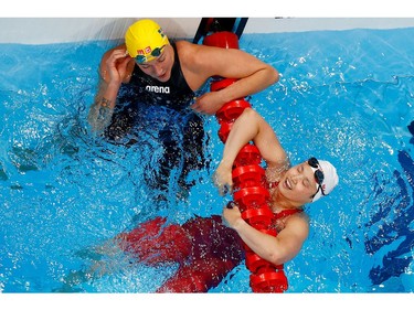 Tokyo 2020 Olympics - Swimming - Women's 100m Butterfly - Final - Tokyo Aquatics Centre - Tokyo, Japan - July 26, 2021. Margaret MacNeil of Canada and Sarah Sjoestroem of Sweden react. REUTERS/Stefan Wermuth/File Photo      SEARCH "OLYMPICS DAY 4" FOR TOKYO 2020 OLYMPICS EDITOR'S CHOICE, SEARCH "REUTERS OLYMPICS TOPIX" FOR ALL EDITOR'S CHOICE PICTURES.