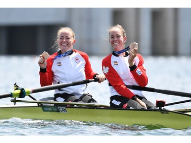 Tokyo 2020 Olympics - Rowing - Women's Pair - Medal Ceremony - Sea Forest Waterway, Tokyo, Japan - July 29, 2021 Bronze medallists Caileigh Filmer of Canada and Hillary Janssens of Canada celebrate with their medals in their boat REUTERS/Piroschka Van De Wouw