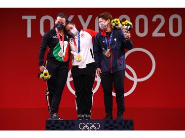 Tokyo 2020 Olympics - Weightlifting - Women's 64kg - Medal Ceremony - Tokyo International Forum, Tokyo, Japan - July 27, 2021. Gold medalist Maude Charron of Canada, silver medalist Giorgia Bordignon of Italy and bronze medalist Chen Wen-Huei of Taiwan react. REUTERS/Edgard Garrido