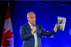 Conservative Leader Erin O'Toole holds a copy of